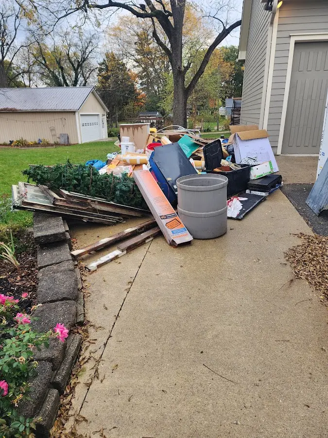 Dumpster being loaded with debris for 10 Yard Dumpster Rental in Brigham City